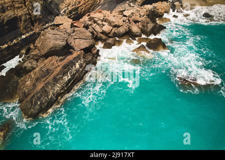 Waves break on rocks Stock Photo