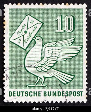 GERMANY - CIRCA 1956: a stamp printed in the Germany shows Pigeon Holding Letter, Day of the Stamp, circa 1956 Stock Photo