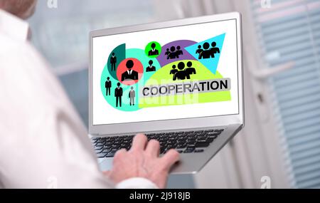 Cooperation concept shown on a laptop used by a man Stock Photo