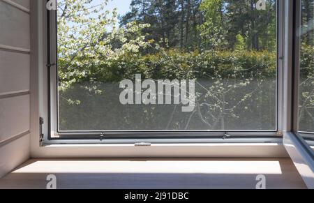 White window with mosuito net in a rustic wooden house Stock Photo