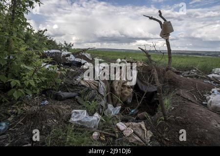 Malaya Rohan, Ukraine. 19th May, 2022. A roll of toilet paper hangs on a branch along with other personal items strewn about by the Russian fighters along a tree line in Malaya Rohan, Ukraine, Wednesday, May 18, 2022. Russians used this tree line to attack traffic on a nearby highway. Finland and Sweden formally submitted applications to join the NATO military alliance early Wednesday, ending the Nordic nations' decades of military neutrality in the wake of Russia's war in Ukraine. Photo by Ken Cedeno/UPI Credit: UPI/Alamy Live News Stock Photo