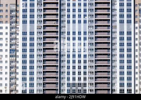 Brightly colored facade of a residential building. Abstract background of windows. Stock Photo