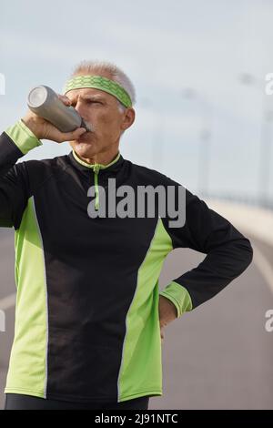 Caucasian senior man drinking water during morning workout horizontal medium shot Stock Photo