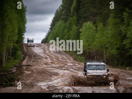 Offroad car on bad muddy road in forest. Mud and water splash in off-road driving Stock Photo