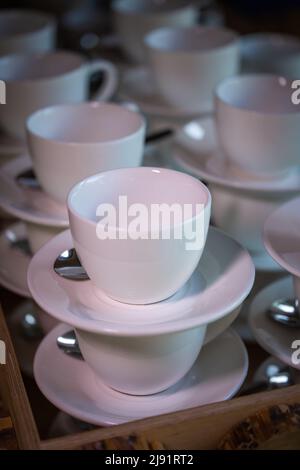 Many rows of white mugs or cups for coffee and tea, standing on top of each other Stock Photo
