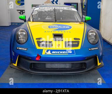 West Kingsdown, Kent, UK – May 15 2022. Front on view of a Porsche racing car in the pitlane garage before an up and coming championship cup race Stock Photo
