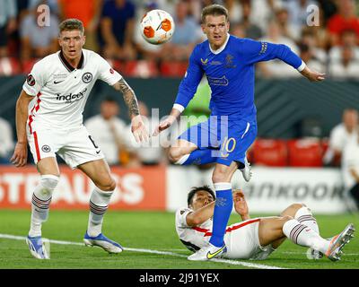 Sevilla, Spain, May 18, 2022, Steven Davis of Rangers FC and Kristijan Jakic, Makoto Hasebe of Eintracht  during the UEFA Europa League, final match between Eintracht Frakfurt and Rangers FC played at Sanchez Pizjuan Stadium on May 18, 2022 in Sevilla, Spain. (Photo by PRESSINPHOTO) Stock Photo