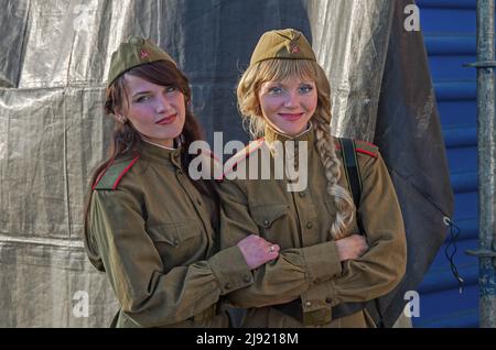Dnipro, Ukraine - October 29, 2013: Two girls, blonde and brunette, in military uniform of the Red Army during Second World War Stock Photo