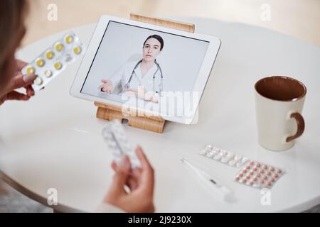 High angle view shot of unrecognizable woman having online appointment with doctor using digital tablet Stock Photo