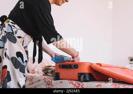 Cropped shot of a mature woman , arranging her luggage, ready to go on a summer trip. concept leisure and hobby Stock Photo