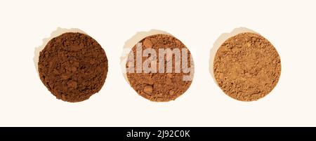 Comparison of dutch process cocoa with natural cocoa powder.Three piles of texture cocoa powder of different colors on a beige background. Top view Stock Photo