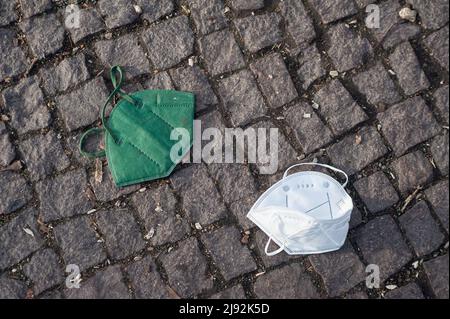12.02.2022, Berlin, , Germany - Europe - Two used and discarded FFP2 protective masks against Corona (Covid-19) lie on the ground. 0SL220212D021CAROEX Stock Photo