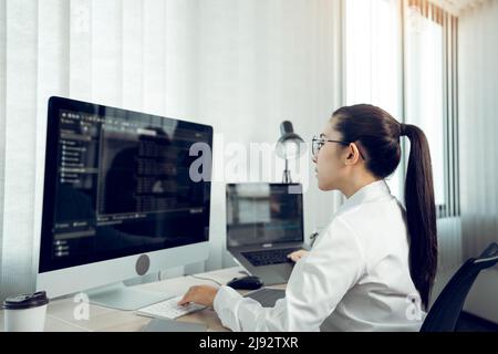 Developing programming and coding technology working in a software engineers developing applications in office. Stock Photo