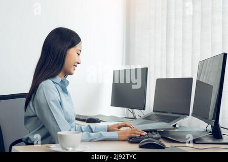 Asian young female programmer working developer programing on a computer code at office. Stock Photo