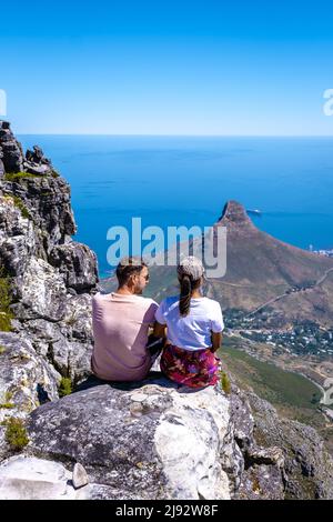 view from the Table Mountain in Cape Town South Africa, view over the ocean, and Lion's Head from Table Mountain Cape Town. couple man and woman on top of Table mountain Stock Photo