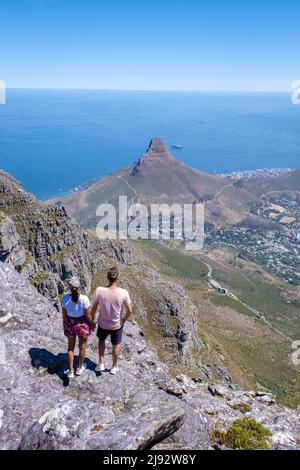 view from the Table Mountain in Cape Town South Africa, view over the ocean, and Lion's Head from Table Mountain Cape Town. couple man and woman on top of Table mountain Stock Photo