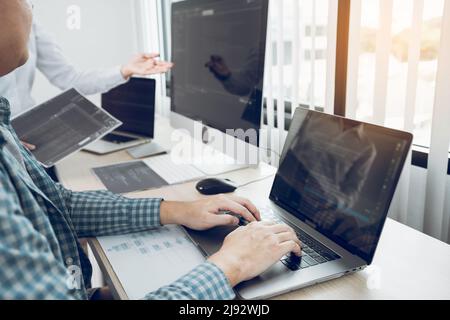 Two asian team working development of programming and encryption technology website design programmers on desk in office. Stock Photo