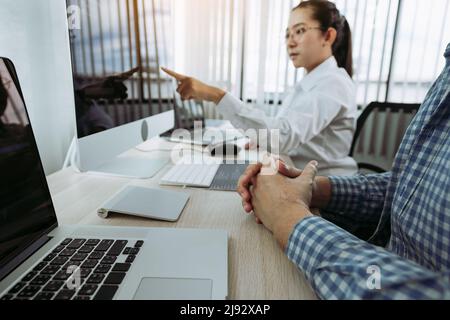 Two partnerships developing programming and coding technologies working on laptop and analyzing together. Stock Photo