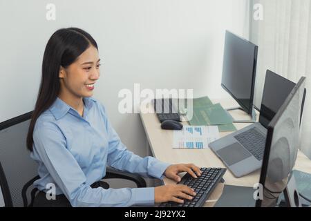 Asian young female programmer working developer programing on a computer code at office. Stock Photo