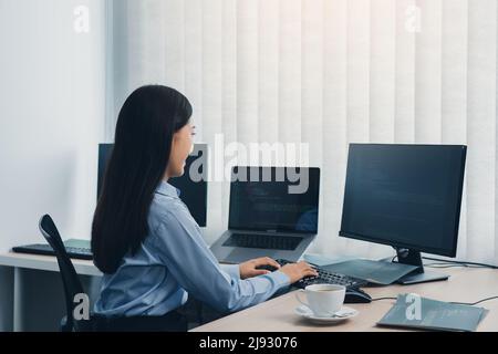 Business woman working on desktop computer monitor professional and sitting at her office desk and working on new software program. Stock Photo