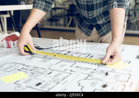 Architects are working on a new project while using a tape measure. Stock Photo