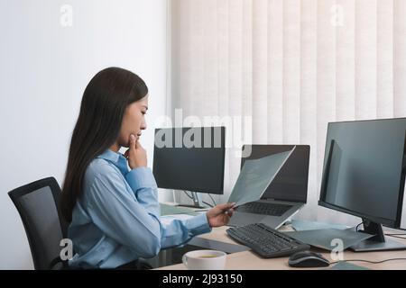 Stress asian woman while coding data programmer on desktop PC while working on computer codes in the office. Stock Photo
