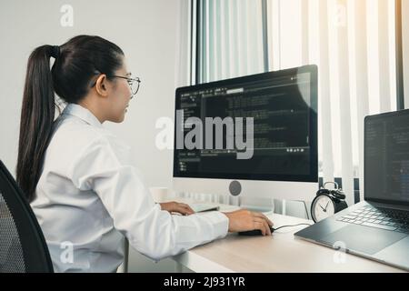 Developing programming and coding technology working in a software engineers developing applications in office. Stock Photo