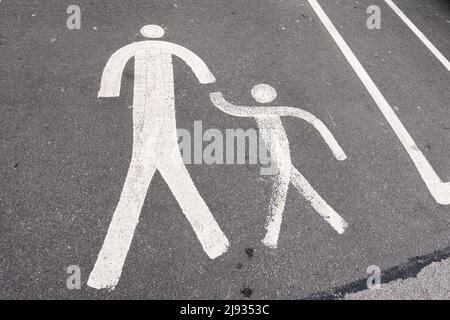 Painted icon of parent and child walking at car park Stock Photo