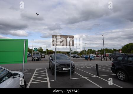 Parent and toddler parking sign at Morrisons supermarket car park and icon painted on ground in parking space Stock Photo