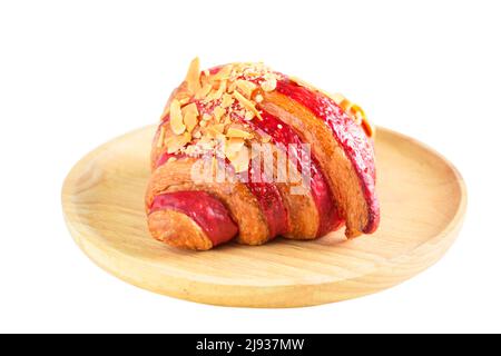 Raspberry Crumble Cream Cheese Croissant on wood plate isolated on white background, Home made bakery concept. Stock Photo