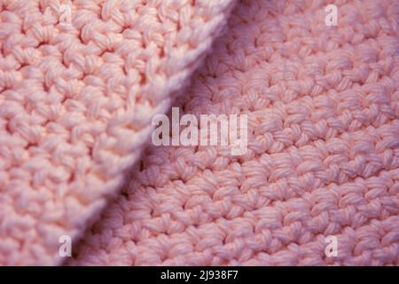 Close up abstract texture background of elegant crocheted fabric with pink yarn Stock Photo