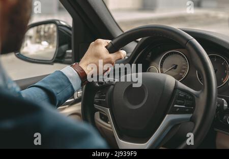 Man is driving a car on the road Stock Photo