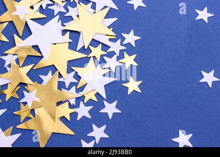 Stars glitter on pink background, selective focus. Festive holiday backdrop. Stock Photo