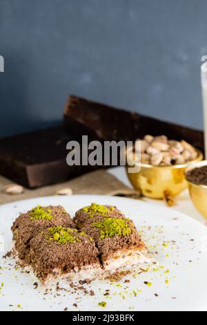 Pistachio cold baklava on white marble. Traditional middle eastern dessert. Turkish Antep baklava. Stock Photo