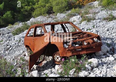 Rusty car wreck abandoned in Mont Faron in Toulon Stock Photo