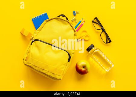 Students supplies in yellow school backpack. Back to school concept Stock Photo