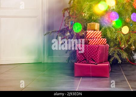 Many different present boxes stacked under Christmas tree Stock Photo