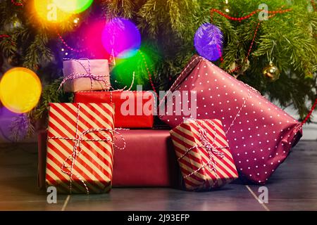 Many different present boxes stacked lay under Christmas tree Stock Photo