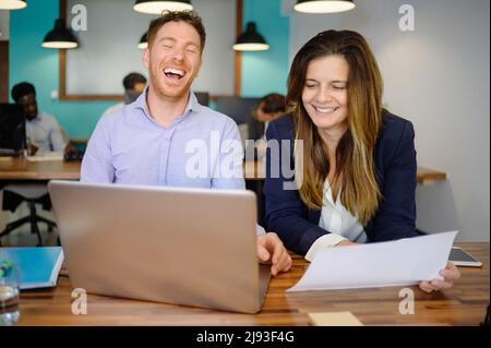 Positive coworkers cooperating during work on project in office Stock Photo