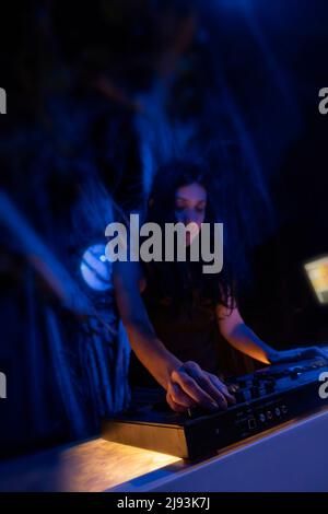 DJ using mixing desk in a club Stock Photo