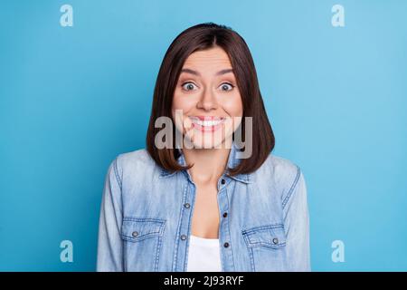 Photo of impressed funny sweet shiny woman wear jeans shirt smiling isolated blue color background Stock Photo