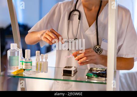 Nurse. Medical. Nurse preparing an injection to give a vaccine in a health center or hospital. Virus disease concept. Phototography. Stock Photo