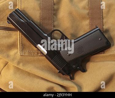 Shotgun resting on messenger bag . Stock Image. Stock Photo