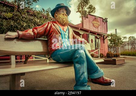 Gold Coast, Queensland, Australia - Old prospector statue sitting on a bench at Dreamworld theme park Stock Photo