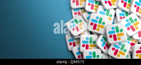 Logos of the workplace messaging system Slack (part of Salesforce) on a heap. Web banner size with copy space - Selective focus Stock Photo