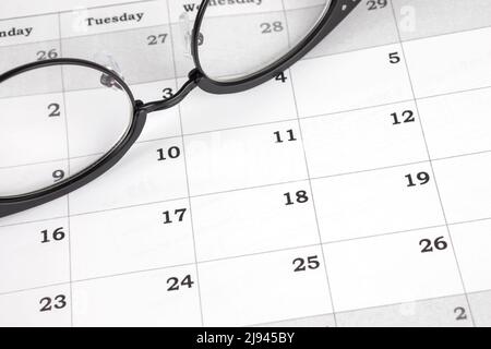 Calendar with eyeglasses as a business schedule, office planner, date organization and daily meeting reminder concept Stock Photo