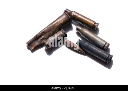 Several empty cartridges and a bullet on a white background Stock Photo