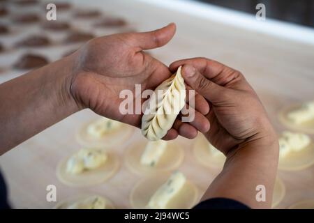 Close-up of female hands showing fresh homemade culurgiones pasta. Italian  typical filled pasta from Sardinia region Stock Photo - Alamy