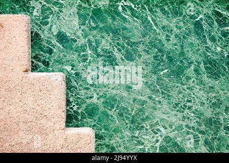 Zigzag shaped concrete structure painted in pink. Stock Photo