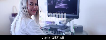 The ultrasound doctor examines the woman's abdominal cavity Stock Photo